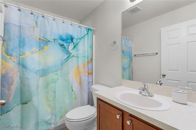 2626 SW 22nd Ave, Cape Coral, FL 33914 - full bathroom with toilet, a shower with curtain, vanity, and visible vents