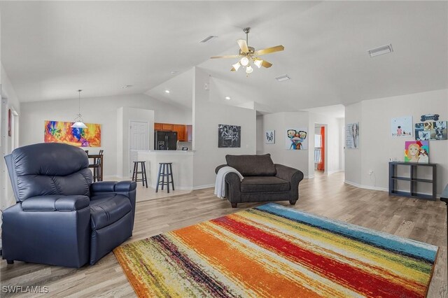 2626 SW 22nd Ave, Cape Coral, FL 33914 - living room featuring vaulted ceiling, ceiling fan, light wood finished floors, baseboards, and visible vents