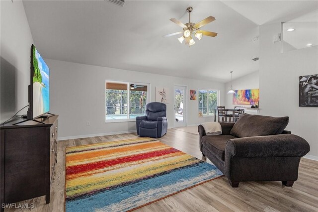 2626 SW 22nd Ave, Cape Coral, FL 33914 - living area featuring vaulted ceiling, visible vents, baseboards, wood finished floors, and ceiling fan
