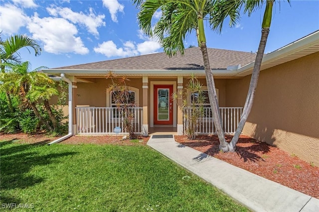 2626 SW 22nd Ave, Cape Coral, FL 33914 - doorway to property with a porch, a shingled roof, a yard, and stucco siding