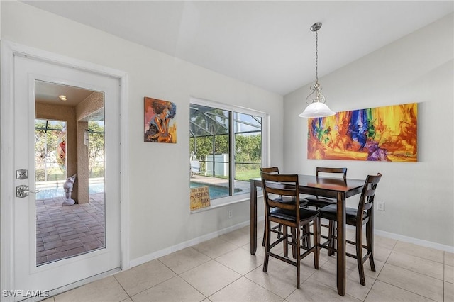 2626 SW 22nd Ave, Cape Coral, FL 33914 - dining room featuring light tile patterned flooring, lofted ceiling, and baseboards