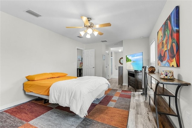 2626 SW 22nd Ave, Cape Coral, FL 33914 - bedroom featuring baseboards, wood finished floors, visible vents, and ceiling fan