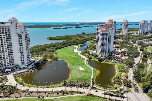 bird's eye view of a large body of water, a local golf course, and apartment complex