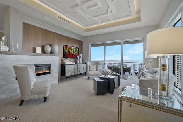 living room with carpet, healthy amount of natural light, and a glass covered fireplace