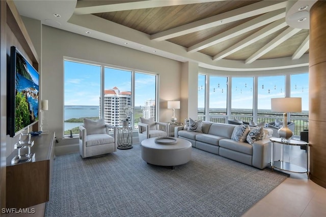 living area with beamed ceiling, wood ceiling, and a water view