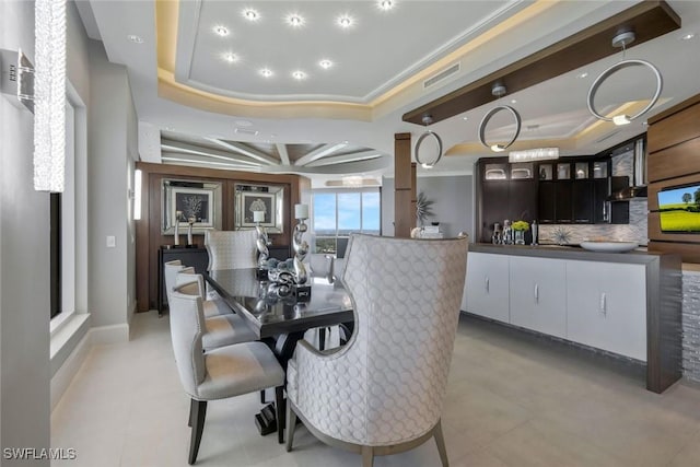 dining room featuring a raised ceiling and crown molding