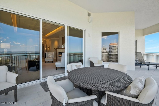 view of patio with a water view and a balcony