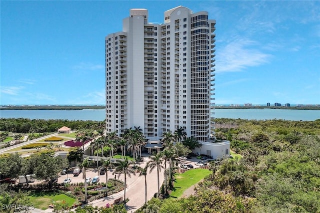 view of property with a water view and a city view