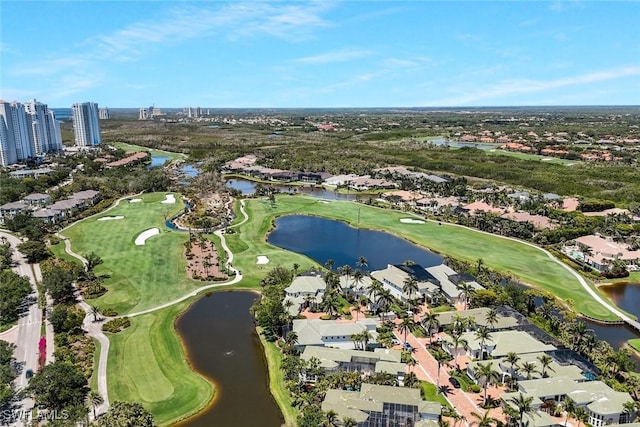 aerial view of property's location featuring nearby suburban area, a local golf course, and a nearby body of water