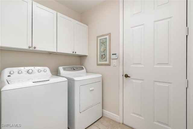 174 Shadroe Cove Cir Unit 1002, Cape Coral, FL 33991 - laundry room with light tile patterned flooring, separate washer and dryer, cabinet space, and baseboards