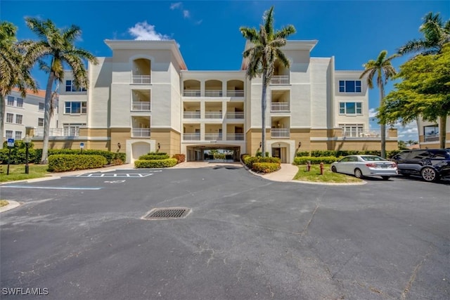 view of building exterior featuring uncovered parking