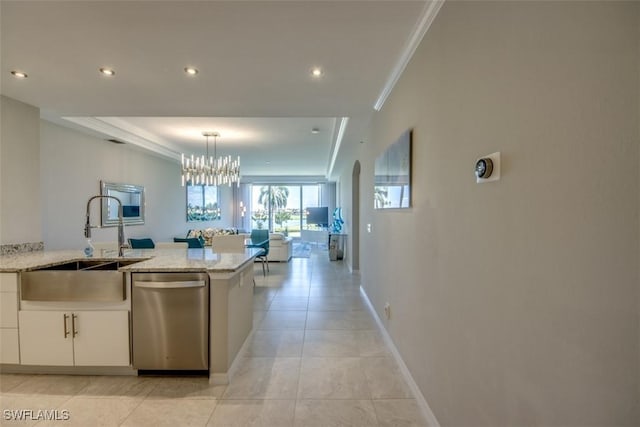 kitchen featuring white cabinets, a sink, an inviting chandelier, light stone countertops, and dishwasher