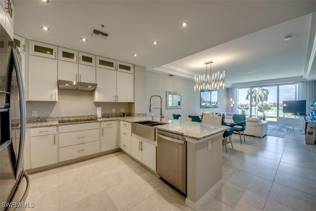 kitchen with a sink, black appliances, white cabinetry, a peninsula, and under cabinet range hood