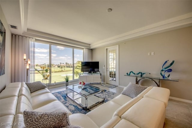living room with baseboards and visible vents