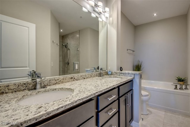 bathroom with a bath, tile patterned floors, a sink, double vanity, and a stall shower
