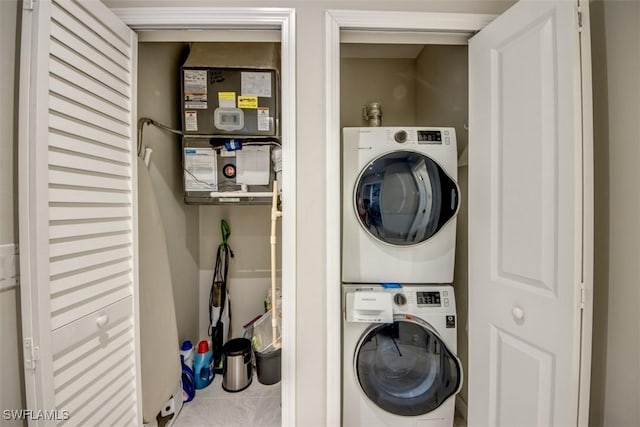 laundry area featuring stacked washer and clothes dryer and laundry area