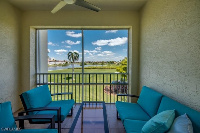sunroom featuring a water view