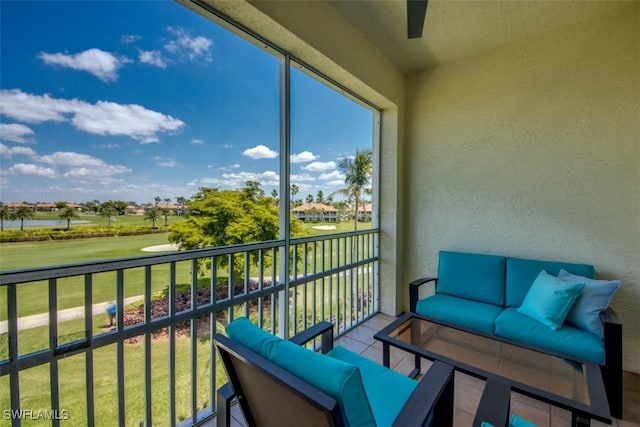 balcony with an outdoor hangout area and view of golf course