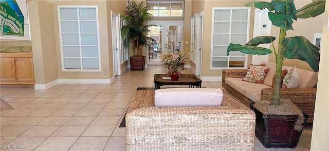living area with baseboards and light tile patterned floors