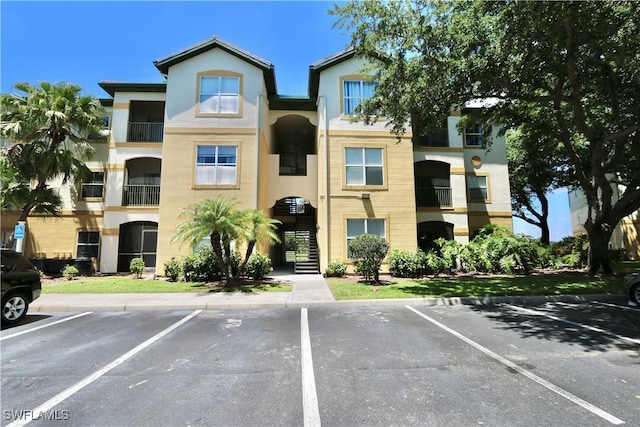 view of property with uncovered parking