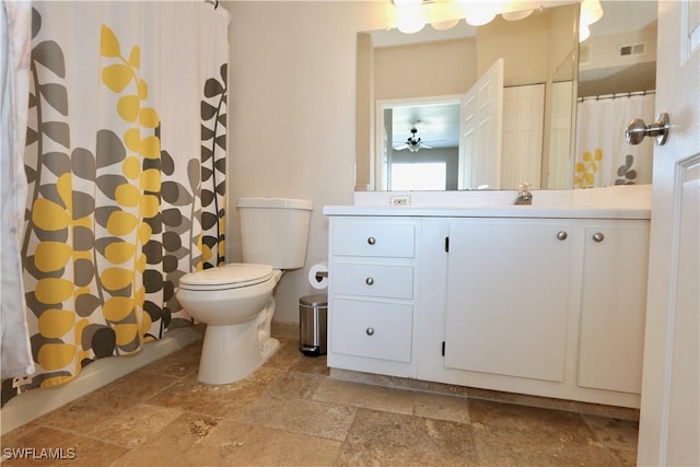 bathroom with a shower with curtain, visible vents, vanity, toilet, and stone tile flooring
