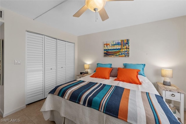 tiled bedroom with visible vents, baseboards, a closet, and ceiling fan