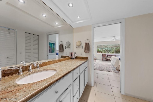 bathroom featuring recessed lighting, tile patterned flooring, vanity, connected bathroom, and a closet