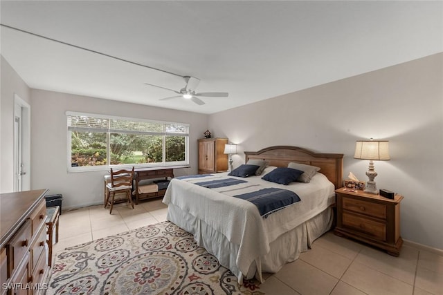 bedroom featuring a ceiling fan, baseboards, and light tile patterned flooring