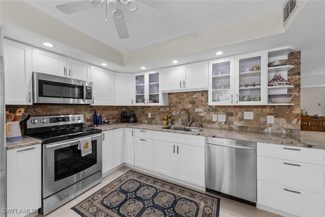 kitchen with tasteful backsplash, stainless steel appliances, visible vents, and a sink