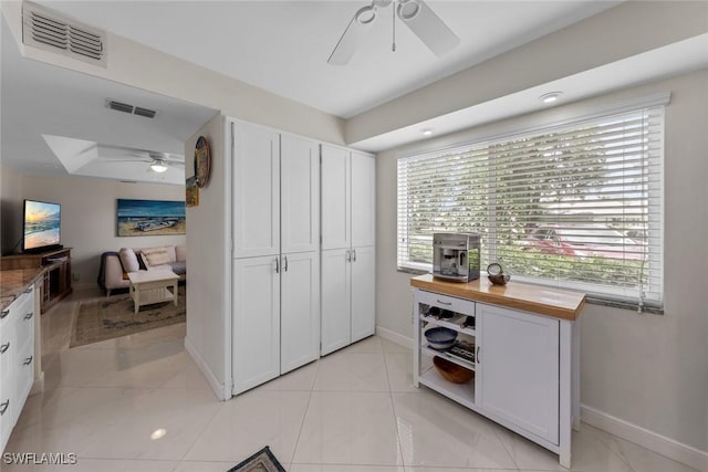 interior space with baseboards, visible vents, and a healthy amount of sunlight