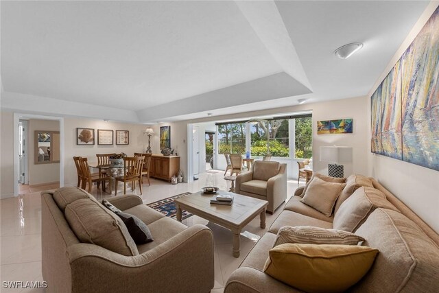 living room with baseboards and light tile patterned flooring