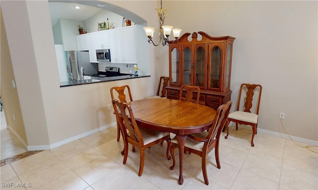 327 Monaco Dr Unit 12, Punta Gorda, FL 33950 - dining room with light tile patterned flooring, arched walkways, and a notable chandelier
