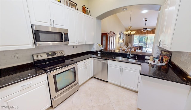 327 Monaco Dr Unit 12, Punta Gorda, FL 33950 - kitchen featuring arched walkways, a sink, white cabinetry, and appliances with stainless steel finishes