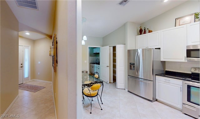 327 Monaco Dr Unit 12, Punta Gorda, FL 33950 - kitchen with visible vents, backsplash, white cabinetry, lofted ceiling, and appliances with stainless steel finishes