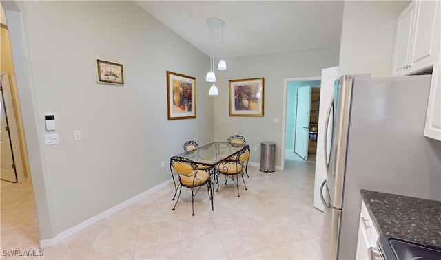 327 Monaco Dr Unit 12, Punta Gorda, FL 33950 - dining space featuring vaulted ceiling, baseboards, and light tile patterned floors