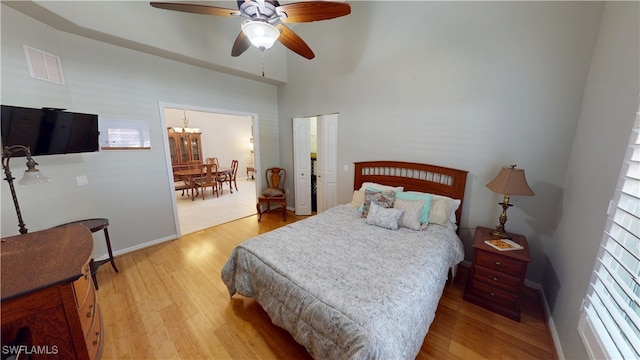 327 Monaco Dr Unit 12, Punta Gorda, FL 33950 - bedroom featuring light wood-type flooring, baseboards, visible vents, and ceiling fan with notable chandelier