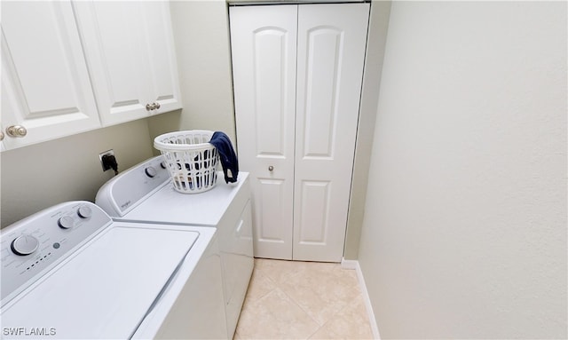 327 Monaco Dr Unit 12, Punta Gorda, FL 33950 - washroom featuring washing machine and clothes dryer, light tile patterned flooring, and cabinet space