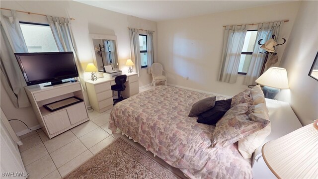 3260 Southshore Dr Unit 65A, Punta Gorda, FL 33955 - bedroom with baseboards, multiple windows, and light tile patterned floors