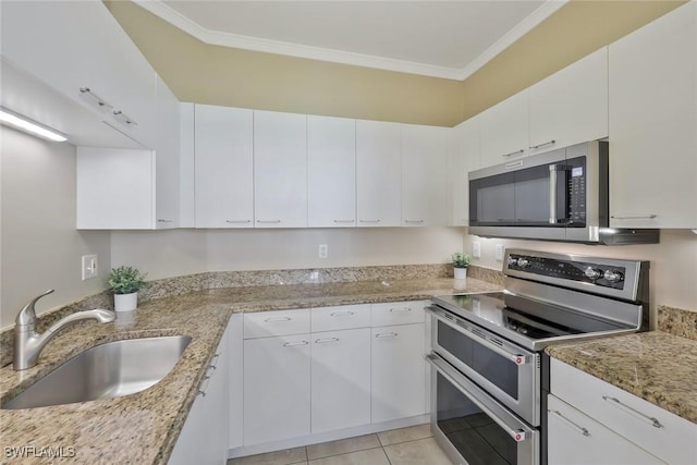 93 Silver Oaks Cir Unit 3-101, Naples, FL 34119 - kitchen with ornamental molding, a sink, white cabinets, and appliances with stainless steel finishes