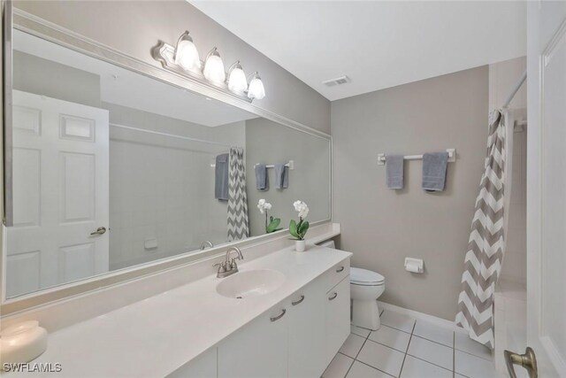 93 Silver Oaks Cir Unit 3-101, Naples, FL 34119 - bathroom featuring visible vents, tile patterned flooring, toilet, vanity, and curtained shower