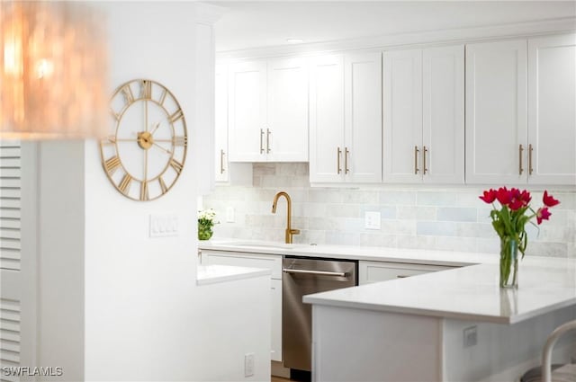 2100 Gulf Shore Blvd N Unit 108, Naples, FL 34102 - kitchen featuring stainless steel dishwasher, a peninsula, light countertops, backsplash, and white cabinets