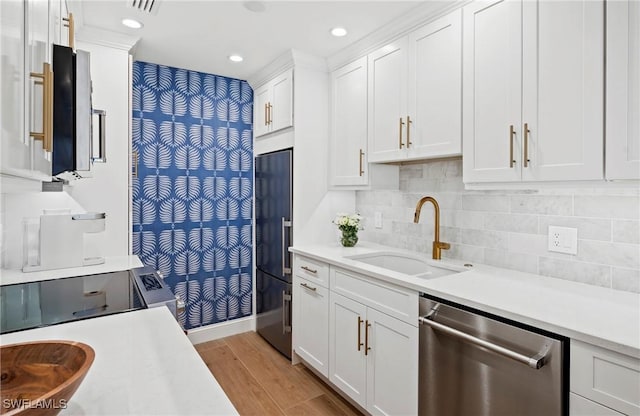 2100 Gulf Shore Blvd N Unit 108, Naples, FL 34102 - kitchen with stainless steel dishwasher, a sink, built in fridge, light countertops, and light wood-type flooring