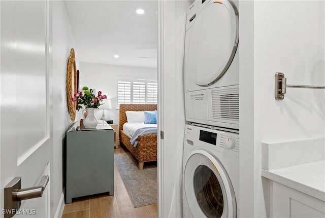2100 Gulf Shore Blvd N Unit 108, Naples, FL 34102 - laundry area featuring stacked washer / drying machine, light wood-type flooring, and recessed lighting