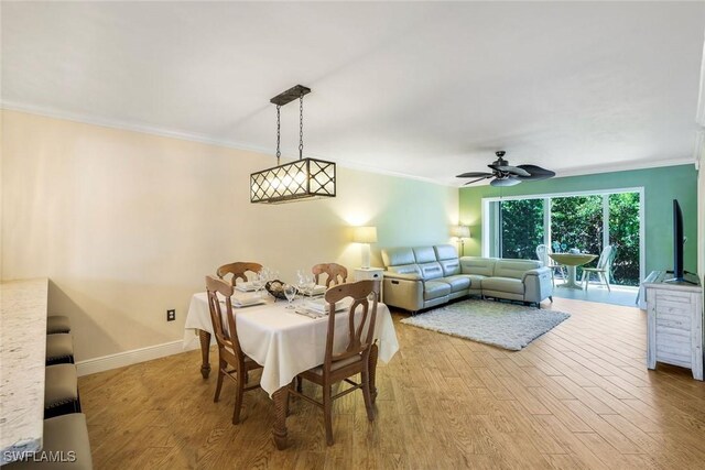 3051 Sandpiper Bay Cir Unit I102, Naples, FL 34112 - dining room with ornamental molding, wood finished floors, and a ceiling fan