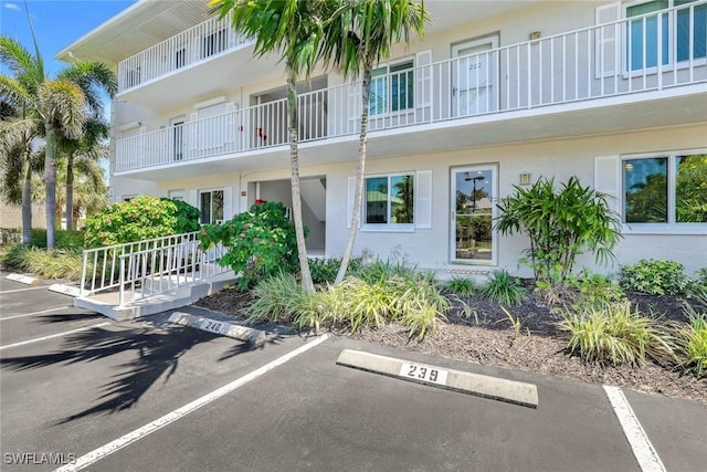 3051 Sandpiper Bay Cir Unit I102, Naples, FL 34112 - view of property featuring uncovered parking