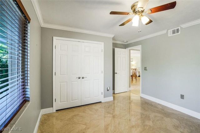 3051 Sandpiper Bay Cir Unit I102, Naples, FL 34112 - unfurnished bedroom featuring light marble finish flooring, ornamental molding, a closet, and a ceiling fan