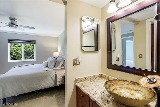 3051 Sandpiper Bay Cir Unit I102, Naples, FL 34112 - ensuite bathroom with tile patterned flooring, vanity, and ceiling fan
