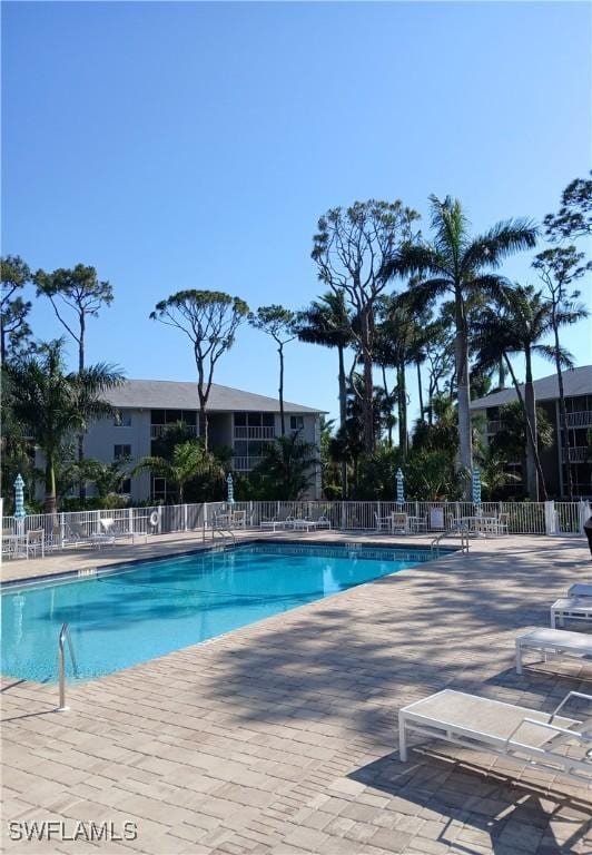 3051 Sandpiper Bay Cir Unit I102, Naples, FL 34112 - community pool featuring a patio