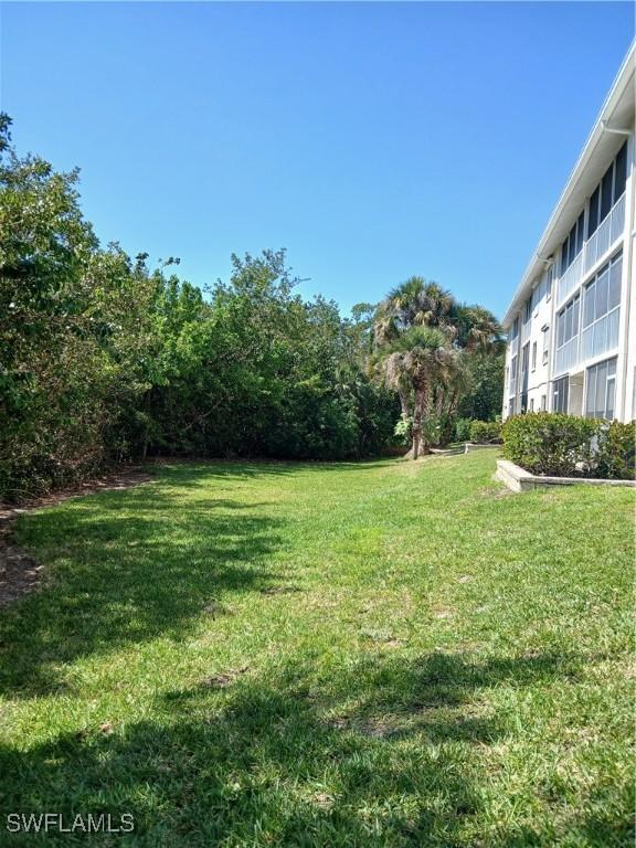 3051 Sandpiper Bay Cir Unit I102, Naples, FL 34112 - view of grassy yard
