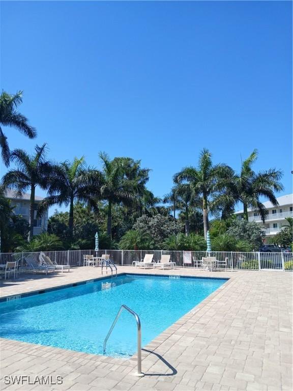 3051 Sandpiper Bay Cir Unit I102, Naples, FL 34112 - community pool featuring a patio area